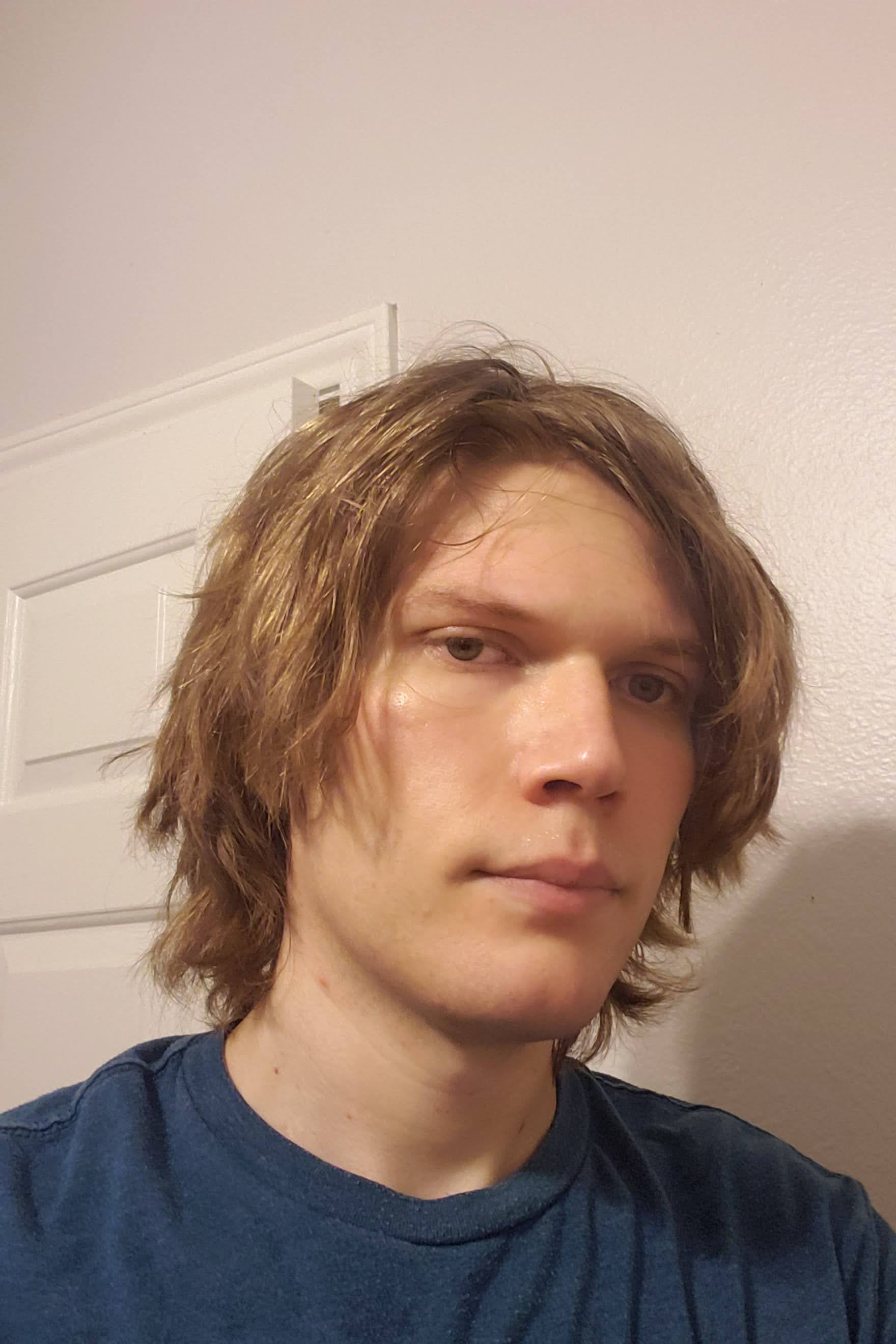 Headshot of me in a white room during the pandemic.