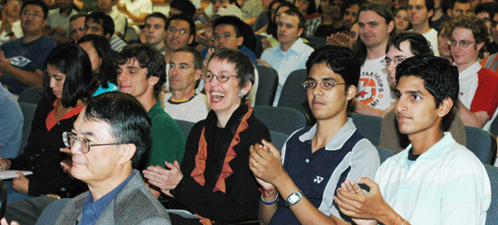 Audience reacting to Professor Cline's speech, Professor Lam, front left