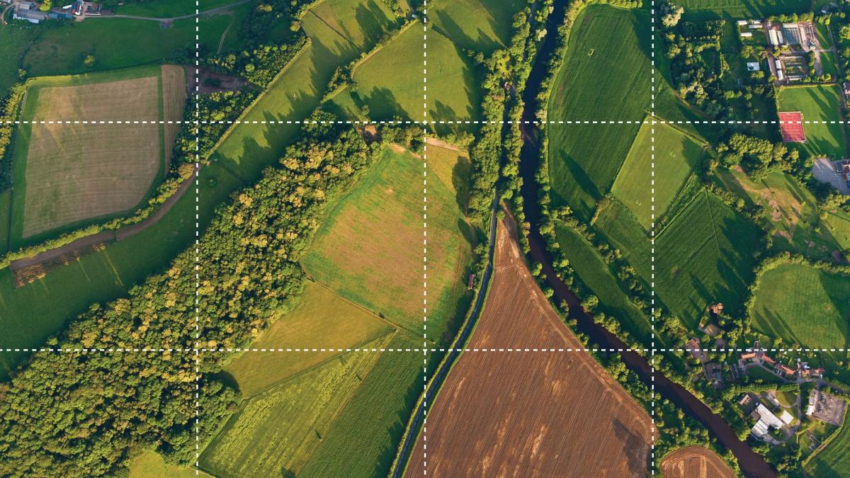 Aerial image showing different types of land use, including farming, forest and housing. Aerial image showing different types of land use, including farming, forest and housing.