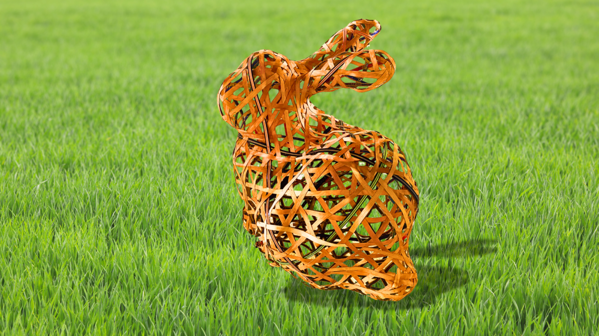 Woven, lattice-like rabbit sculpture made of brown wooden strips, positioned on green grass with a soft, blurred background.