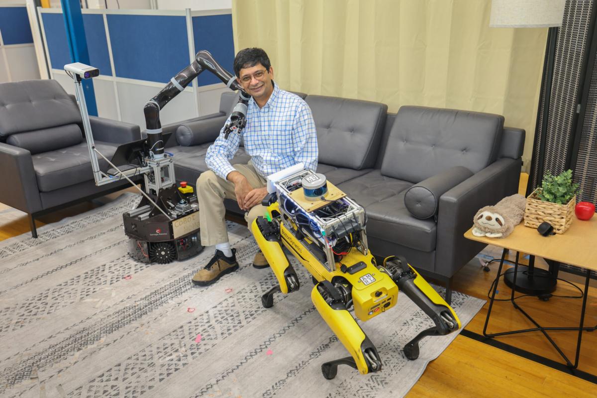 Joydeep posing with robots