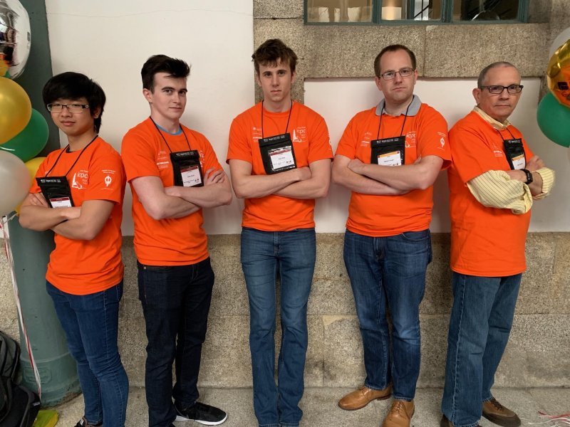ICPC competitors from UT stand together as a group at the competition