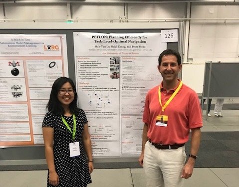 Researchers stand by their poster at conference in Stockholm