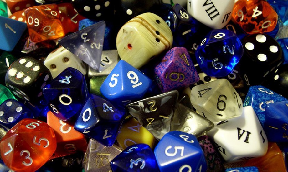 Pile of different colored and shaped dice.