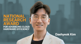 Daehyeok Kim National Recognition for Cloud Hardware Innovation A professional portrait of Daehyeok Kim, smiling and wearing glasses and a light-colored blazer. Bold text on the left reads "National Research Award for Advancing Cloud Hardware Efficiency" against a blurred cityscape background. His name appears on the right side in white text.