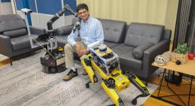 Joydeep posing with robots