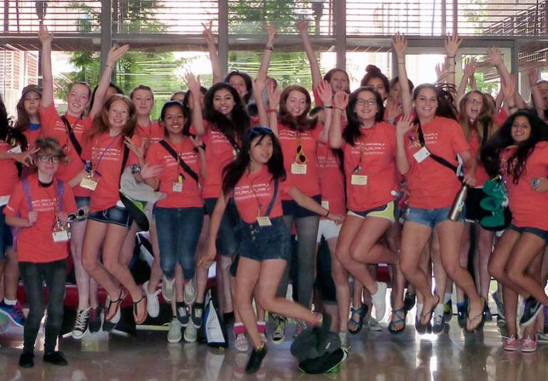 High school junior and senior girls jumping in the air.