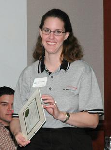Geri Castanon, BAE Systems, receives a recognition certificate from J Moore, UTCS chair.
