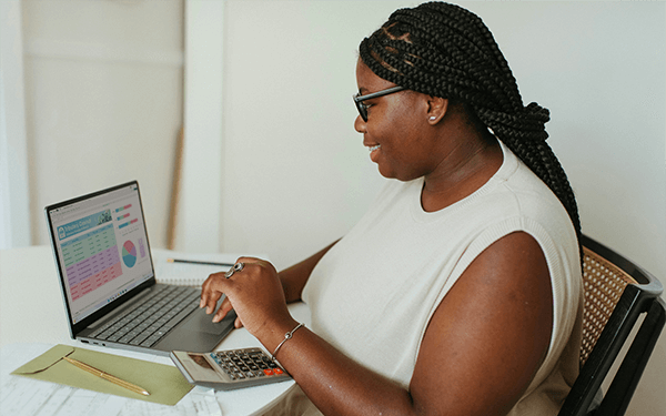 A person typing on a laptop at a desk, working or studying
