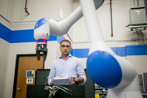 Dr. Chetan Kapoor with a dual-arm, SDA10F robot