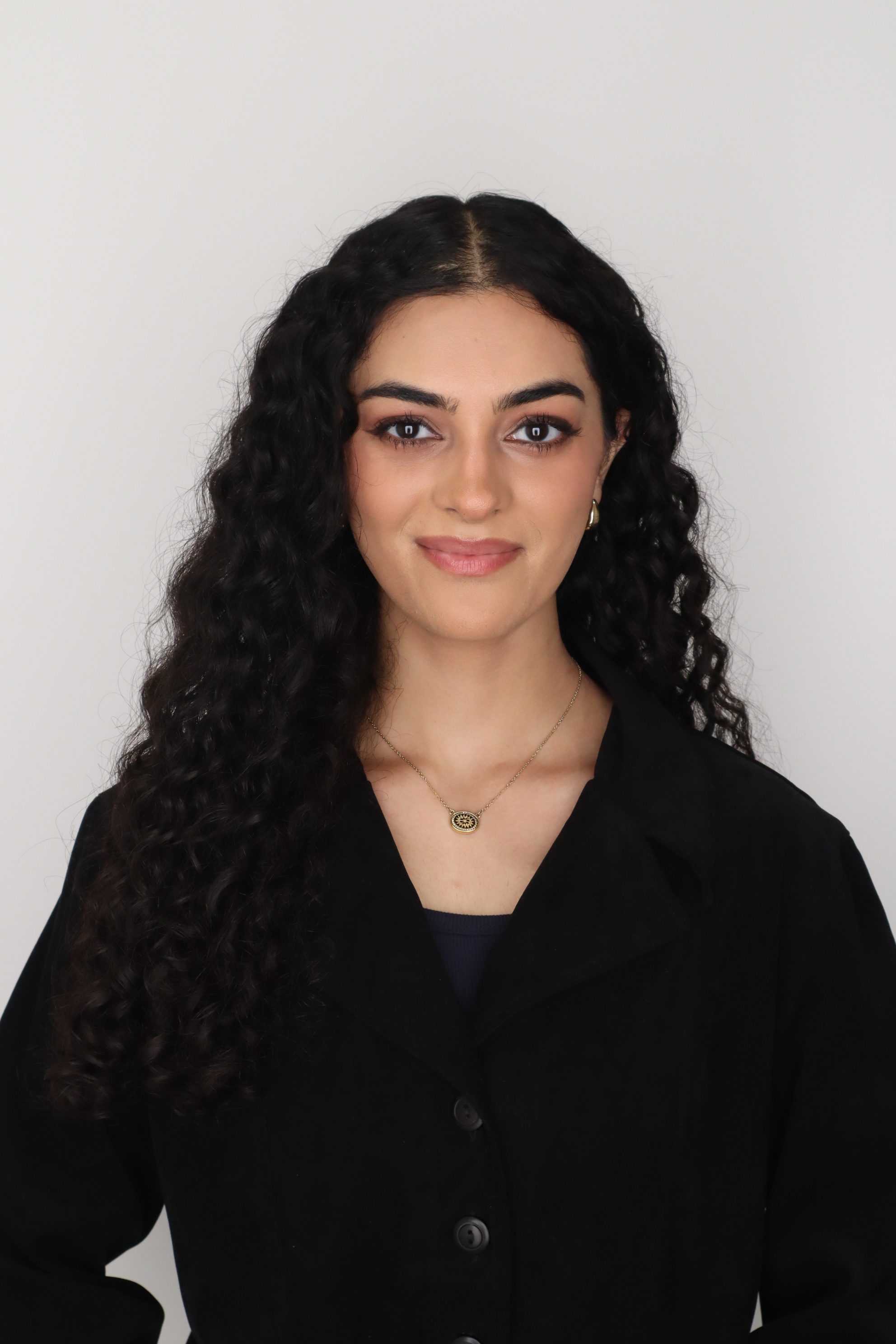 Professional headshot of Abha Misaqi