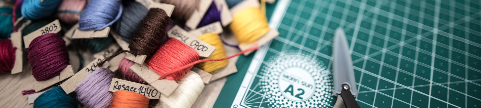 Sewing thread by a mat with scissors