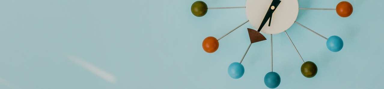 Clock ahdn pointing to spheres