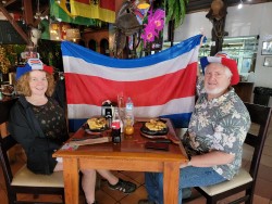 Elaine and Alan at breakfast with the Costa Rican flag