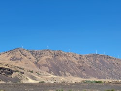 A windfarm on a ridge above the river